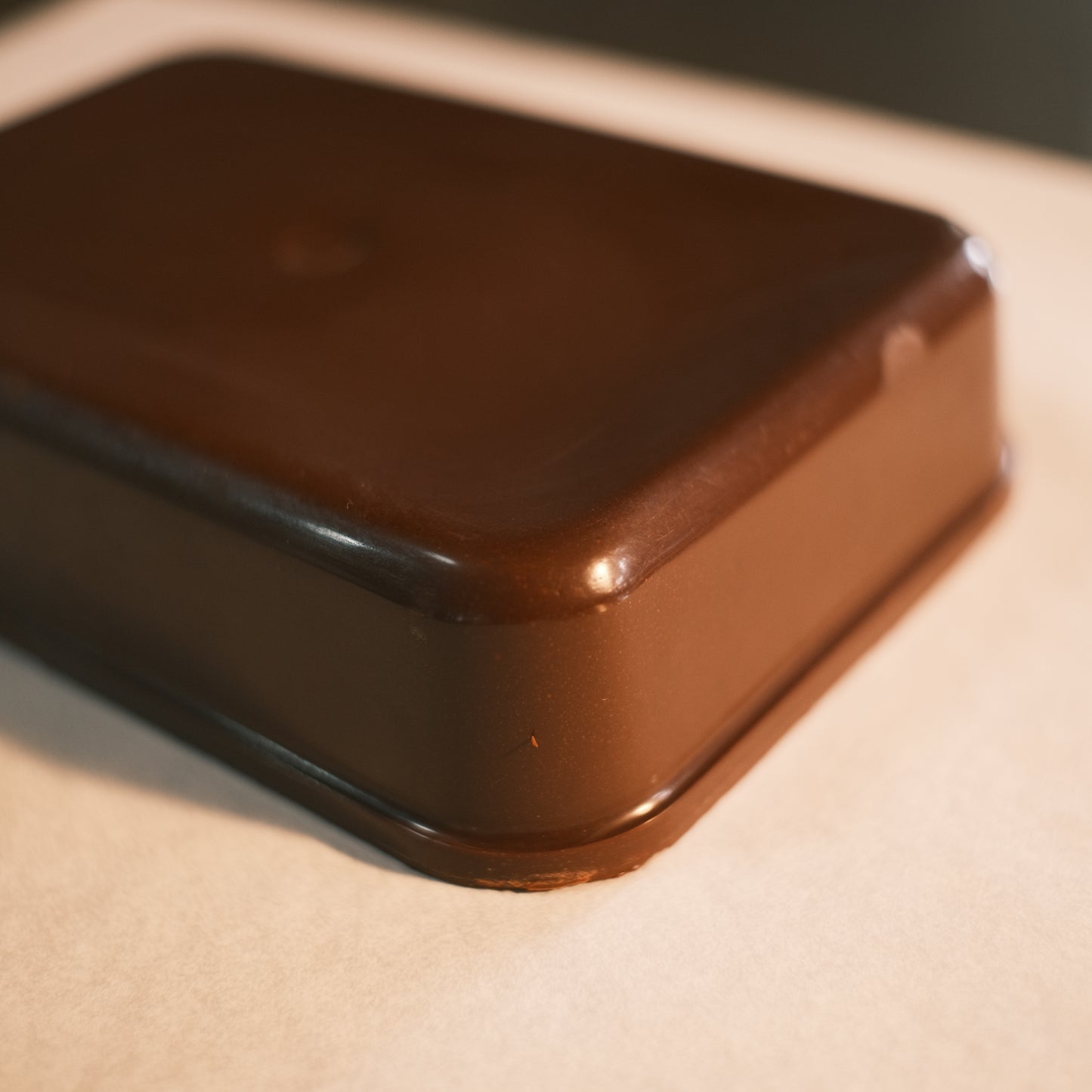 Closeup of cacao block texture – smooth ceremonial cacao for rituals or hot chocolate