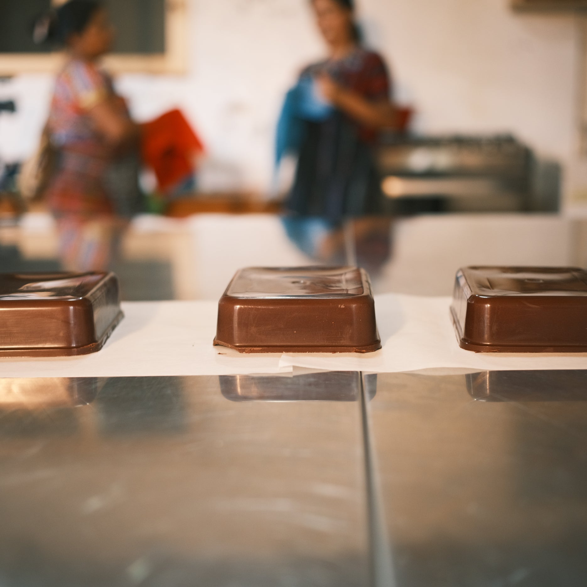Cacao blocks being molded by hand – traditional cacao paste preparation in Mayan Guatemala